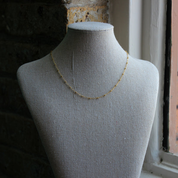 14kt gold-filled small beaded chain shown on a jewelry neck display. Designed by Margie Edwards Jewelry.