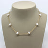 White 8mm pearls with delicate  14kt gold-filled chain in-between. This is a Margie Edwards Jewelry design.  Shown on a jewelry neck.