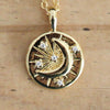 Gold celestial coin necklace featuring a crescent moon, sparkling crystal accents and starburst design