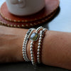 The silver Ashley bracelet beautifully stacked with other bracelet and designed by Margie Edwards Jewelry 