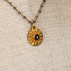 Gold necklace  with a flower pendant. The inside of the pendant  has the labradorite stone. The  pendant is strung on labradorite chain. A Margie Edwards Jewelry Design. 
