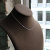 Small beautiful sterling silver necklace designed by Margie Edwards Jewelry. Shown on a brown Jewelry Necklace Display. 